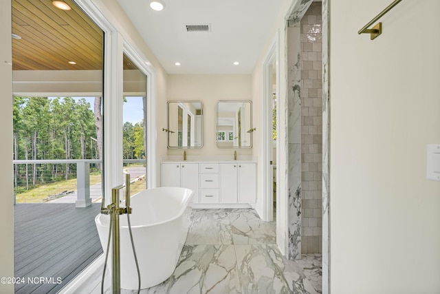 bathroom with vanity and separate shower and tub