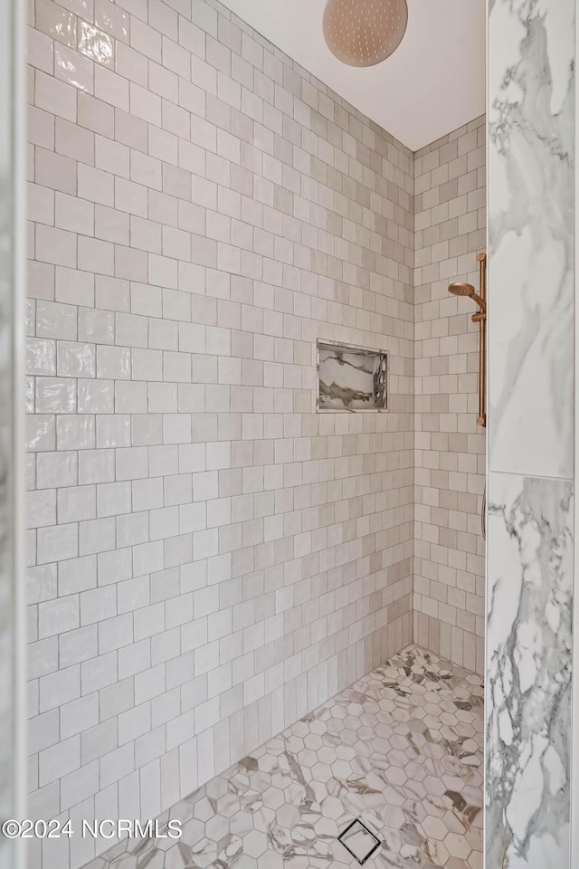 bathroom with tiled shower