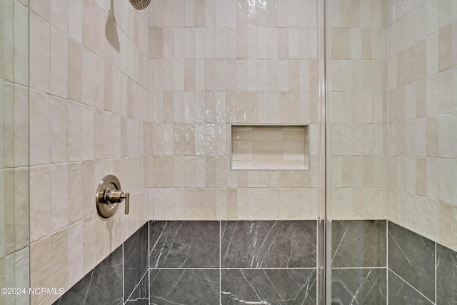 bathroom with tiled shower