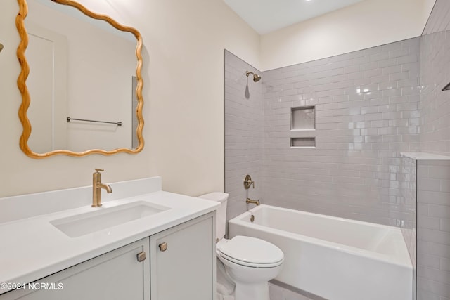 full bathroom with tiled shower / bath combo, vanity, and toilet