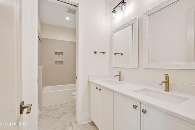 full bathroom with vanity, tiled shower / bath combo, and toilet