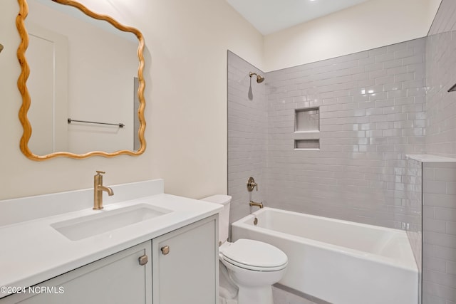 full bathroom with vanity, toilet, and tiled shower / bath