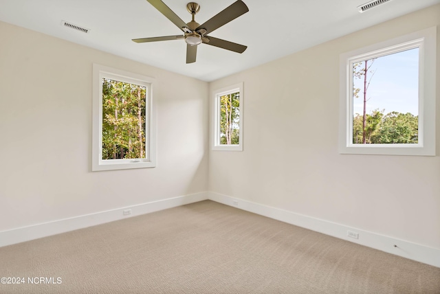 unfurnished room featuring light carpet and ceiling fan