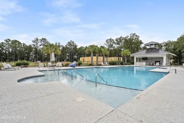 view of swimming pool with a gazebo and a patio