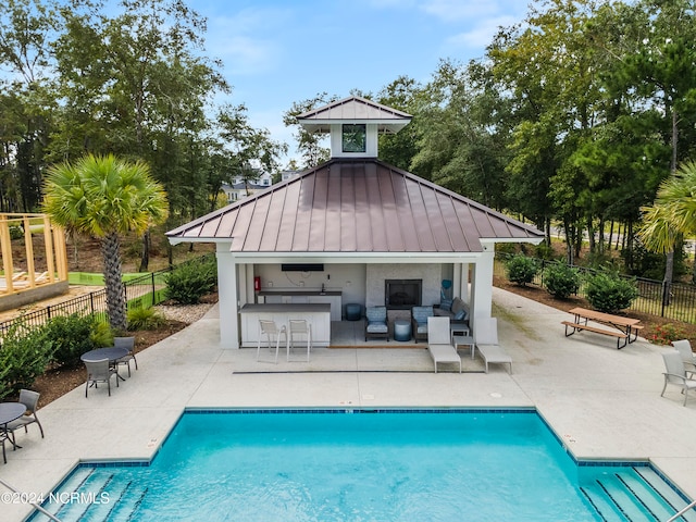 view of pool featuring an outdoor living space and a patio area