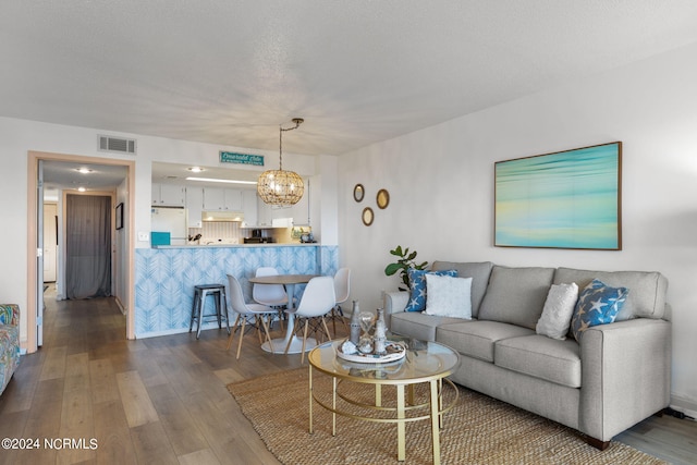 living room featuring a notable chandelier and wood-type flooring