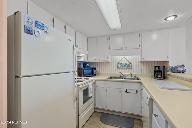 kitchen featuring a textured ceiling, white appliances, sink, white cabinets, and light hardwood / wood-style floors