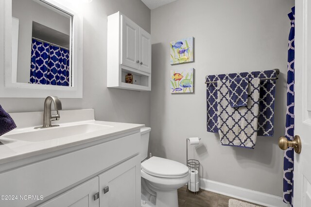 bathroom featuring vanity and toilet