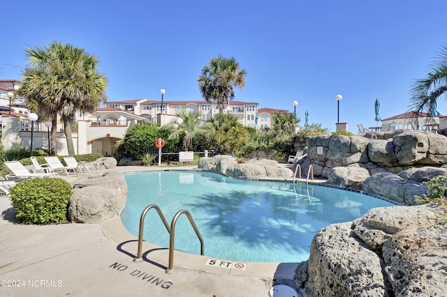 view of swimming pool with a patio