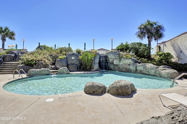 view of pool featuring pool water feature