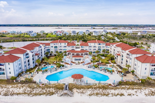 birds eye view of property with a water view