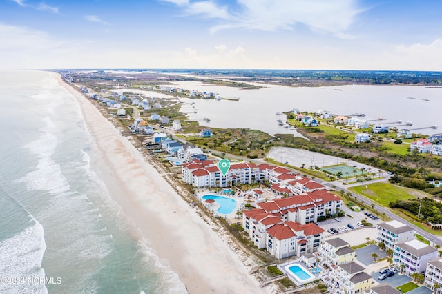 birds eye view of property with a water view and a view of the beach