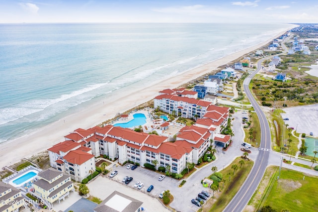 drone / aerial view with a water view and a beach view