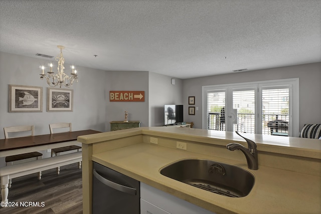 kitchen featuring dishwasher, sink, a chandelier, hanging light fixtures, and dark wood-type flooring