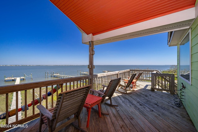 wooden terrace featuring a water view