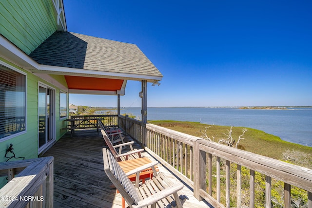 wooden deck featuring a water view