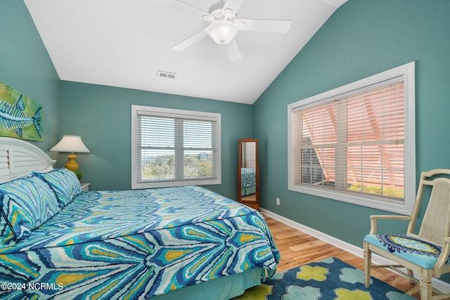 bedroom featuring ceiling fan, wood-type flooring, and lofted ceiling