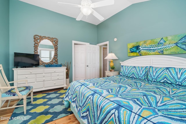 bedroom featuring hardwood / wood-style flooring, lofted ceiling, and ceiling fan