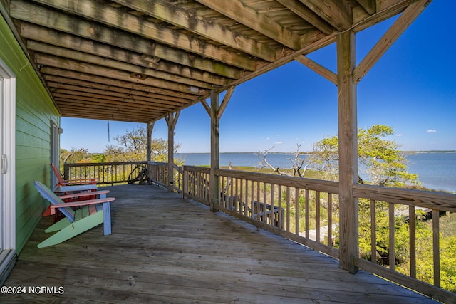 wooden terrace featuring a water view