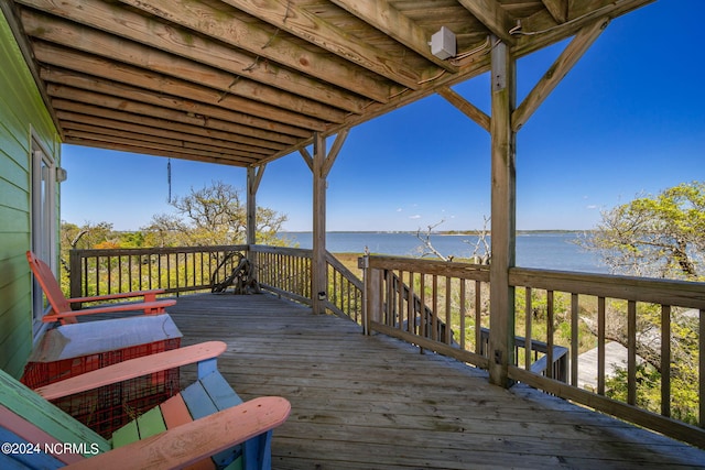 wooden terrace featuring a water view