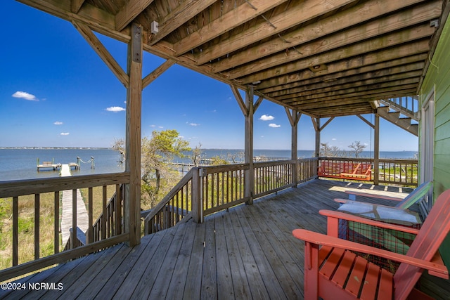 wooden terrace featuring a water view