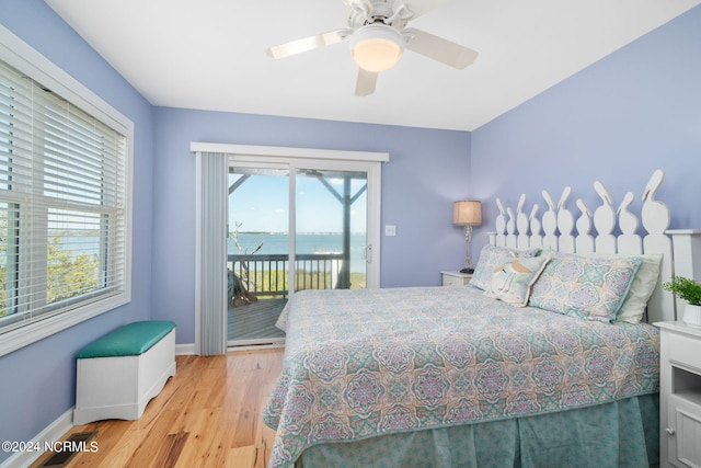 bedroom with a water view, access to exterior, ceiling fan, and light hardwood / wood-style flooring