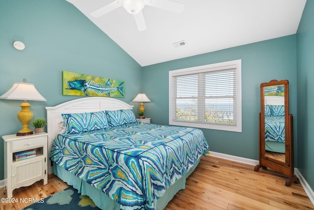 bedroom featuring hardwood / wood-style floors, vaulted ceiling, and ceiling fan