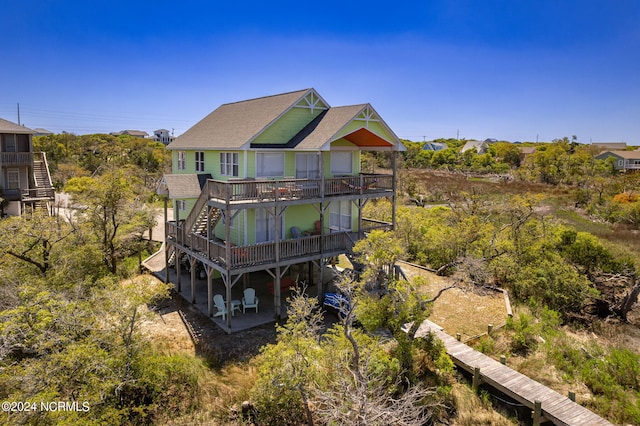 rear view of property featuring a deck