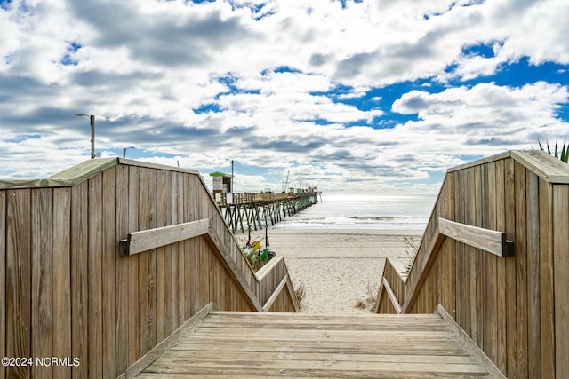 view of property's community featuring a water view and a view of the beach