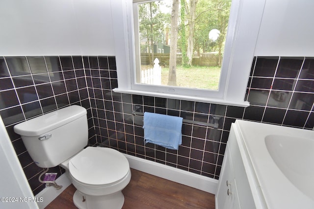 bathroom featuring tile walls, vanity, toilet, and hardwood / wood-style flooring