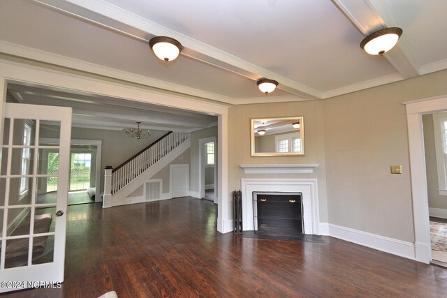 unfurnished living room with beamed ceiling, an inviting chandelier, and dark wood-type flooring