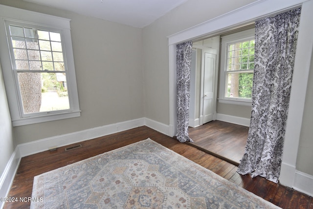 spare room with dark hardwood / wood-style floors