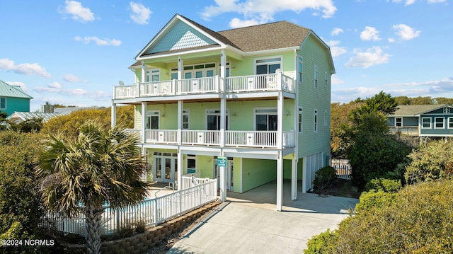 back of house with a balcony and french doors