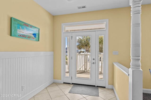 doorway to outside with light tile floors