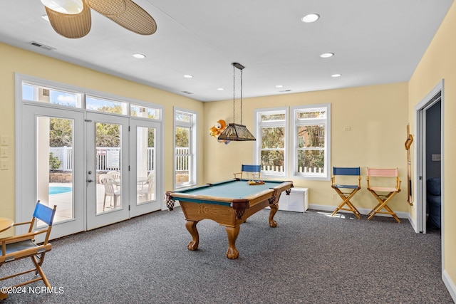 recreation room with billiards, ceiling fan, dark colored carpet, and plenty of natural light