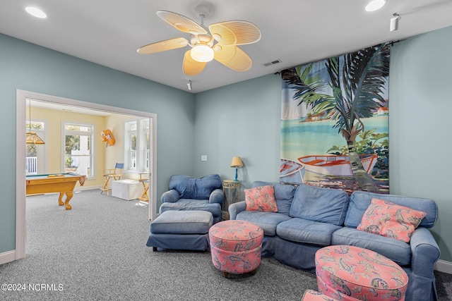 carpeted living room with ceiling fan and pool table