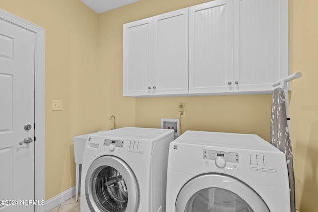 laundry room featuring hookup for a washing machine, independent washer and dryer, cabinets, and light tile flooring