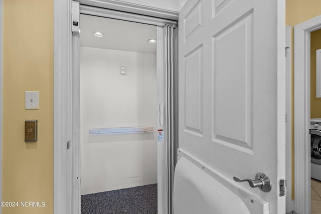 bathroom with washer / clothes dryer and tile flooring