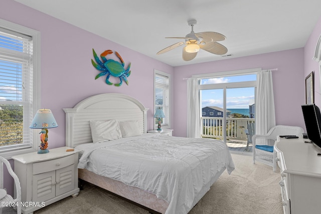 carpeted bedroom with ceiling fan and access to exterior