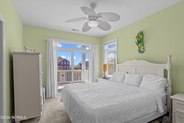 bedroom featuring ceiling fan, access to exterior, and light carpet