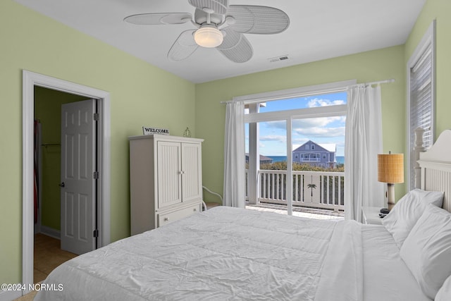 bedroom with ceiling fan, tile flooring, and access to outside