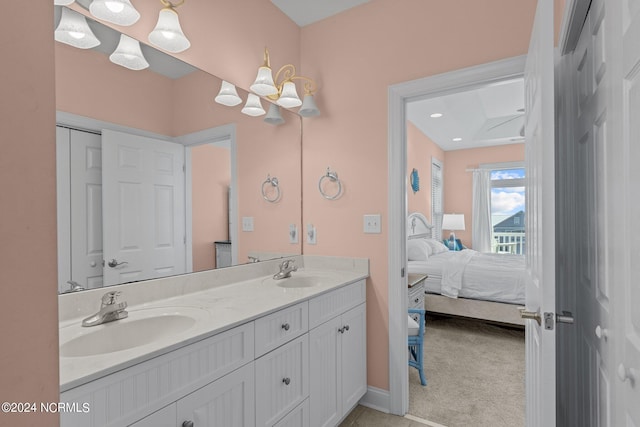 bathroom with dual sinks and vanity with extensive cabinet space