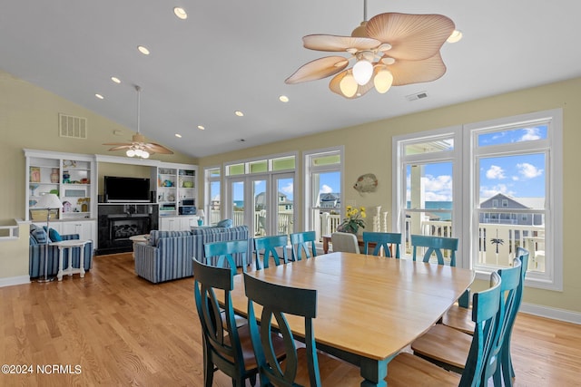 dining room with ceiling fan, lofted ceiling, and light hardwood / wood-style floors