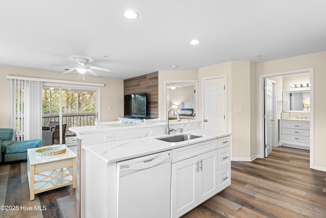 kitchen with a center island, white dishwasher, sink, dark hardwood / wood-style flooring, and white cabinetry