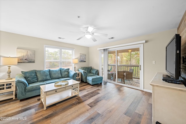 living room with ceiling fan and wood-type flooring