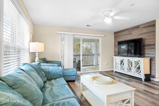 living room with ceiling fan and wood-type flooring