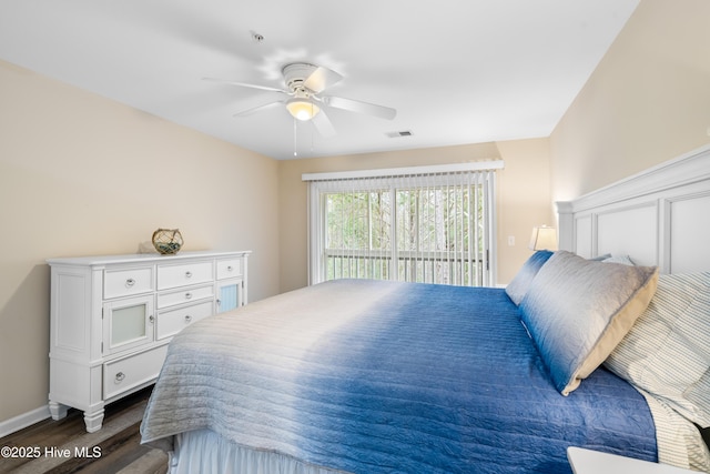 bedroom with ceiling fan, dark hardwood / wood-style floors, and access to outside