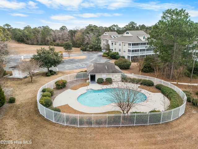 surrounding community featuring a pool, a patio area, and a lawn