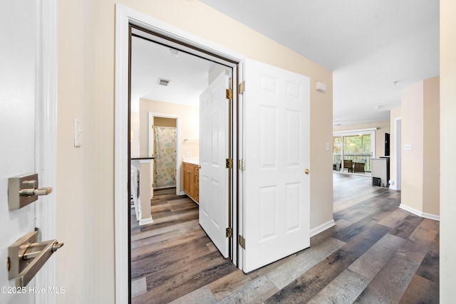 hall with dark wood-type flooring