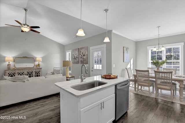 kitchen featuring stainless steel dishwasher, pendant lighting, a center island with sink, white cabinetry, and sink